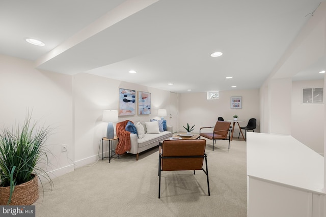 living area featuring light colored carpet, visible vents, baseboards, and recessed lighting