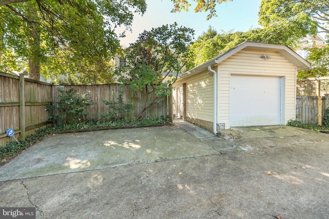 detached garage featuring fence