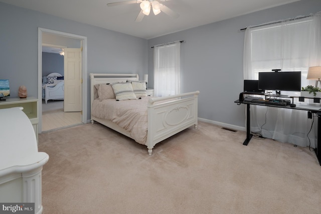 bedroom featuring light carpet, visible vents, and baseboards