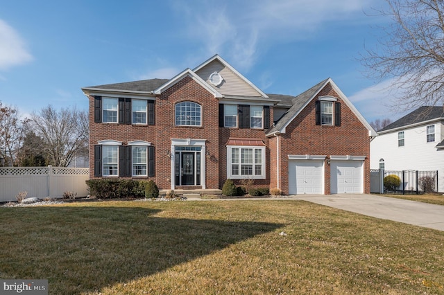 colonial inspired home featuring brick siding, concrete driveway, an attached garage, fence, and a front lawn