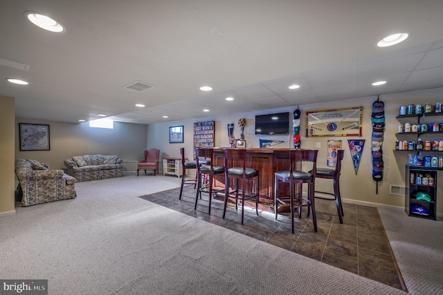 bar with recessed lighting, carpet flooring, visible vents, and a bar