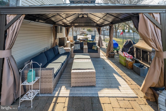 view of patio with an outdoor hangout area, a gazebo, and fence