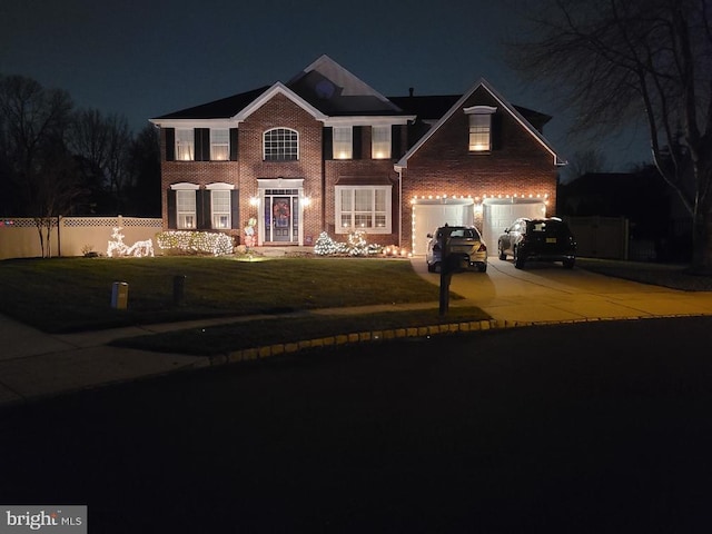 view of front of home with a garage, brick siding, fence, driveway, and a lawn