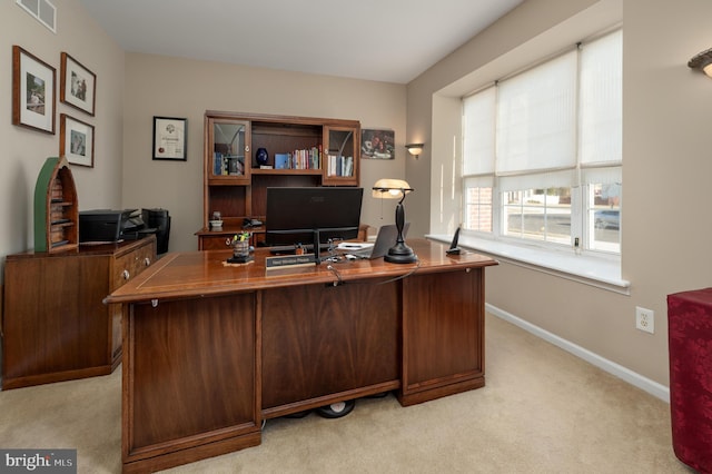 office with baseboards, visible vents, and light colored carpet