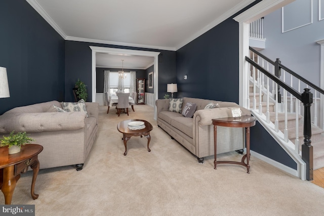 living area with stairway, ornamental molding, carpet flooring, a chandelier, and baseboards