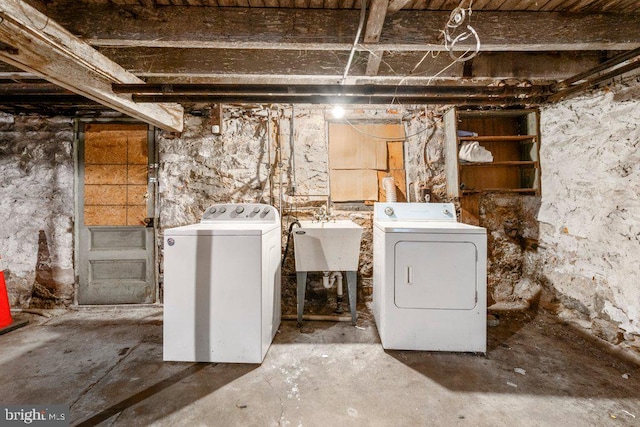 laundry area featuring laundry area, washer and clothes dryer, and a sink