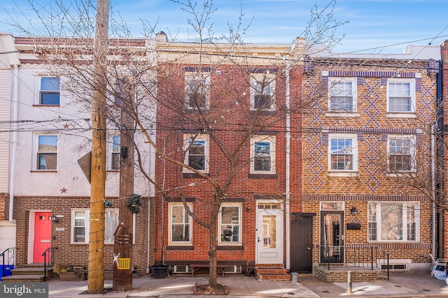 view of front of home featuring entry steps and brick siding