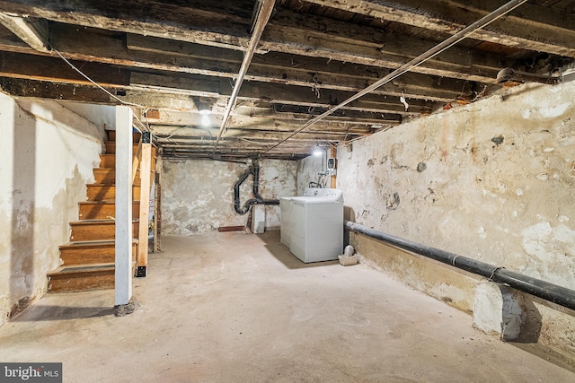 unfinished basement with washer / clothes dryer and stairs