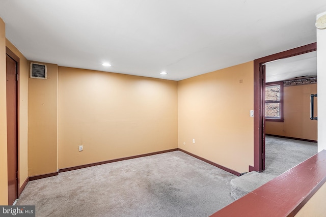 carpeted spare room with recessed lighting, visible vents, and baseboards