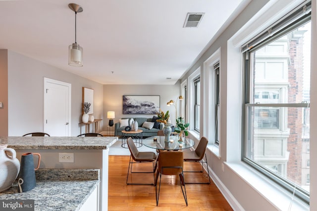 dining space with plenty of natural light, visible vents, and light wood-style floors