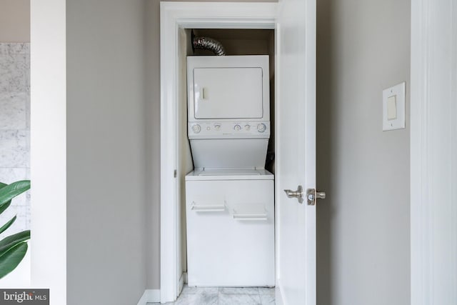 clothes washing area featuring laundry area and stacked washer / drying machine