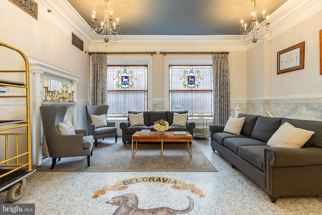 carpeted living room featuring crown molding, wainscoting, a notable chandelier, and visible vents