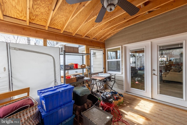 sunroom featuring lofted ceiling, wooden ceiling, and a ceiling fan