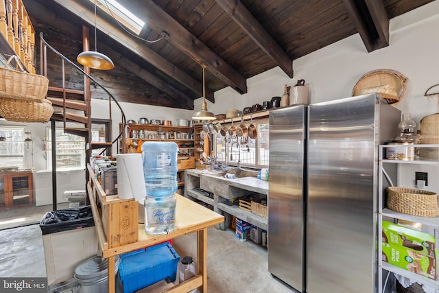 interior space with concrete flooring, freestanding refrigerator, wood ceiling, and vaulted ceiling with beams