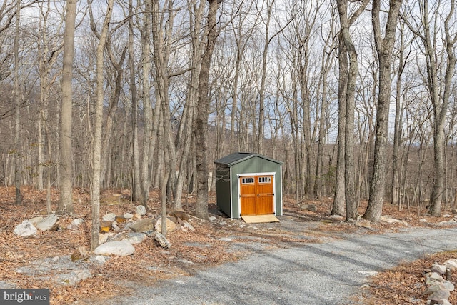 view of shed featuring a forest view