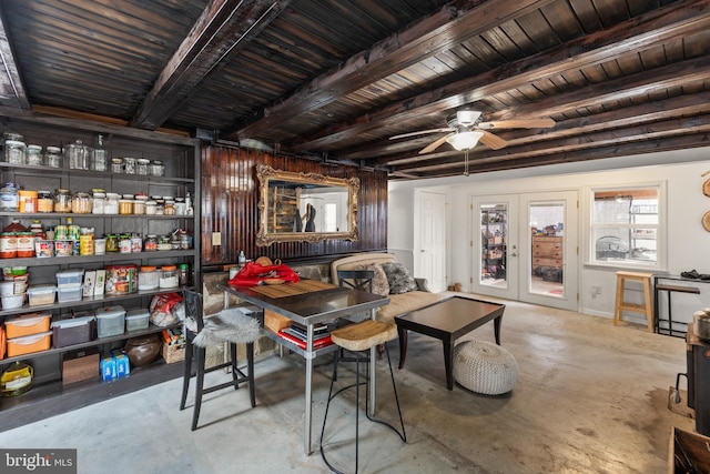 interior space with french doors, unfinished concrete flooring, beamed ceiling, and ceiling fan