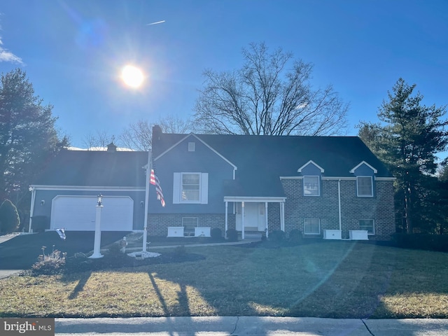 view of front of house featuring aphalt driveway, a chimney, and an attached garage