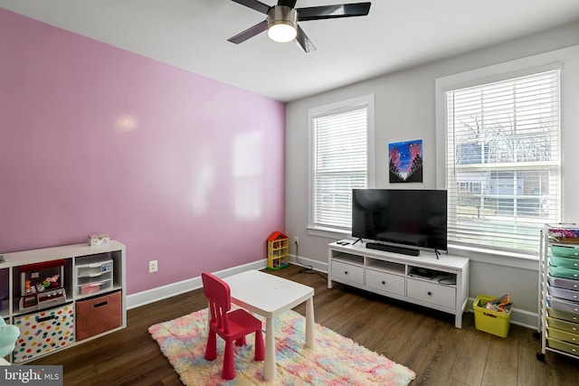 recreation room with ceiling fan, baseboards, and wood finished floors