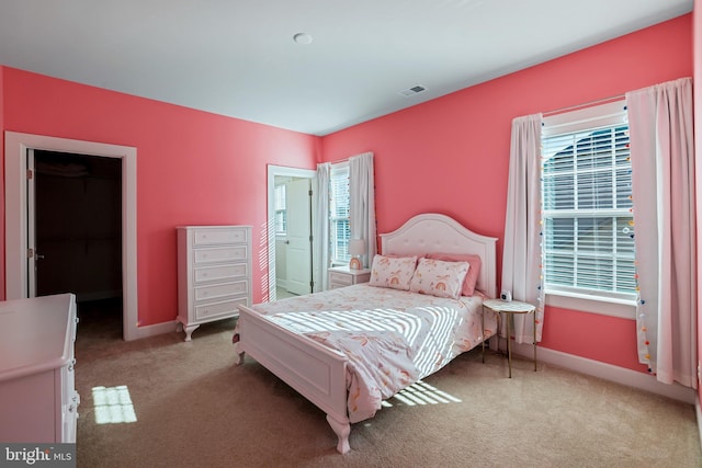 bedroom with carpet floors, visible vents, and baseboards