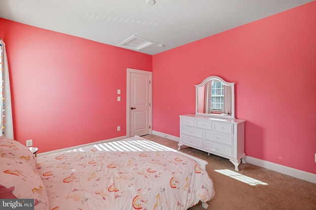 carpeted bedroom with attic access and baseboards