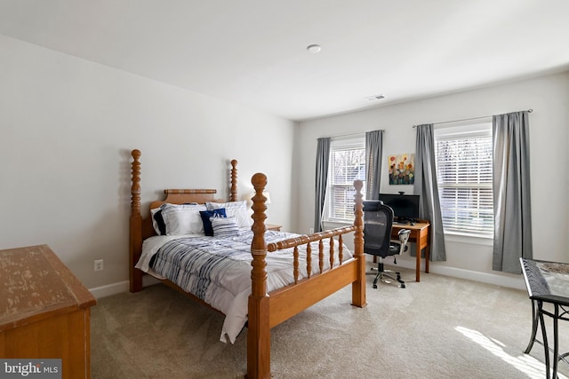 bedroom with light colored carpet, visible vents, and baseboards