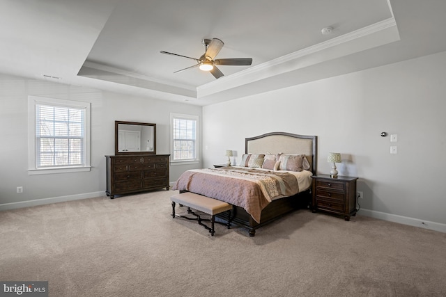 bedroom with a raised ceiling, light carpet, crown molding, and baseboards