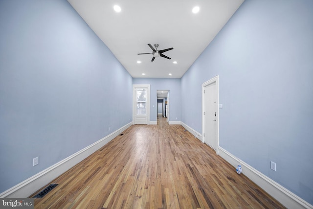 unfurnished living room with ceiling fan, recessed lighting, wood finished floors, visible vents, and baseboards