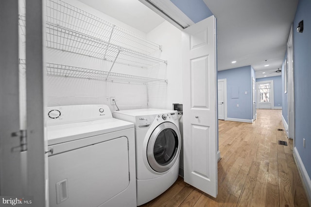 washroom with light wood finished floors, recessed lighting, separate washer and dryer, laundry area, and baseboards