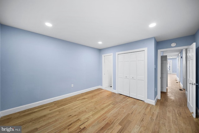 unfurnished bedroom with light wood finished floors, baseboards, and recessed lighting