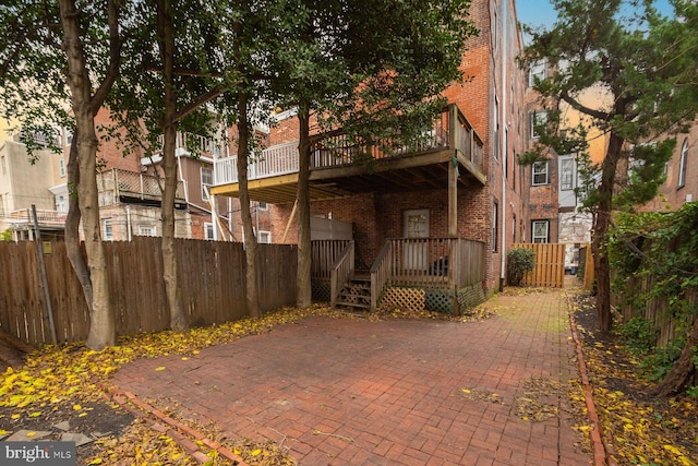 back of house featuring fence private yard, a patio, and brick siding