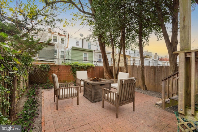 view of patio / terrace featuring a fenced backyard and a fire pit