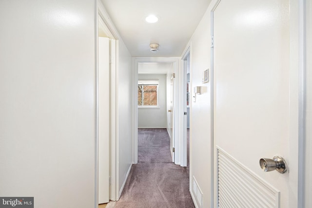 corridor with baseboards and carpet floors