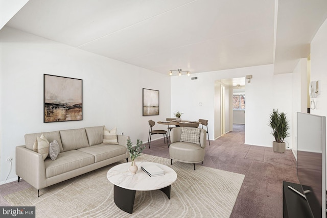 carpeted living room featuring visible vents and baseboards