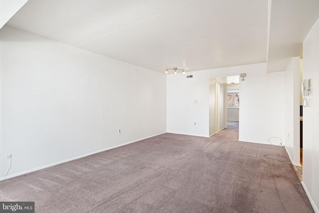 carpeted spare room with visible vents and baseboards