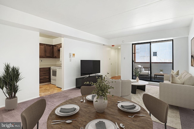 dining room featuring baseboards, light carpet, and visible vents