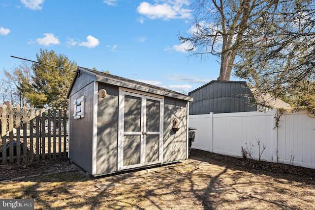 view of shed with a fenced backyard