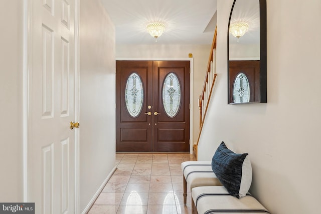 entrance foyer with stairway and baseboards