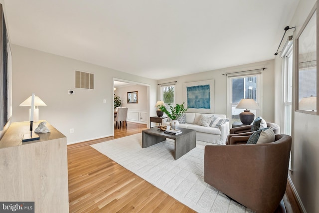 living room with visible vents and wood finished floors