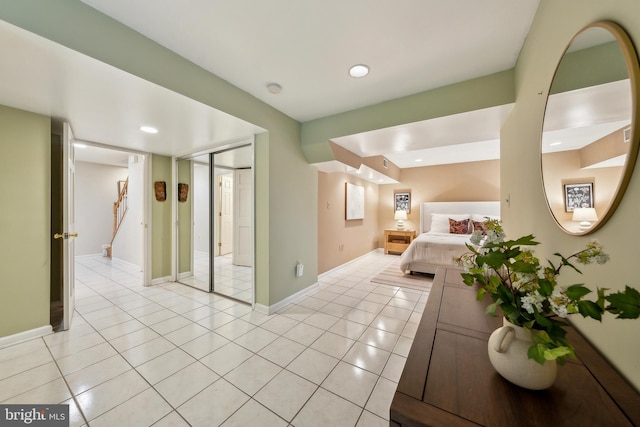 hall with recessed lighting, baseboards, and light tile patterned floors