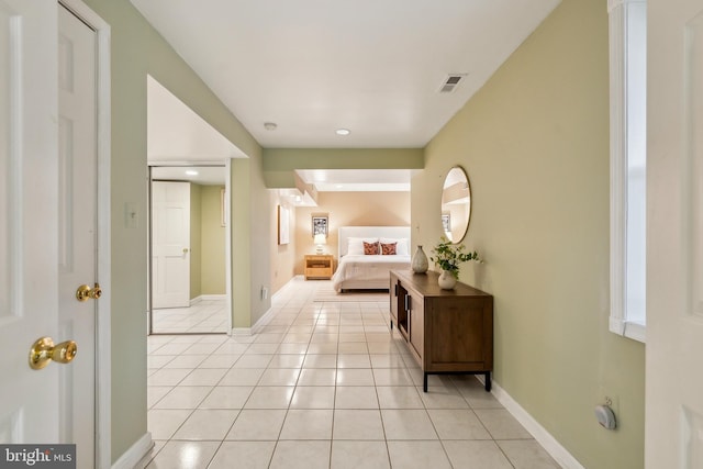 bedroom with light tile patterned floors, baseboards, and visible vents