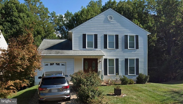 view of front of property featuring an attached garage and a front yard