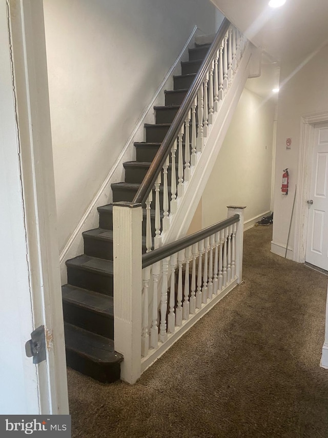 stairway with carpet and baseboards