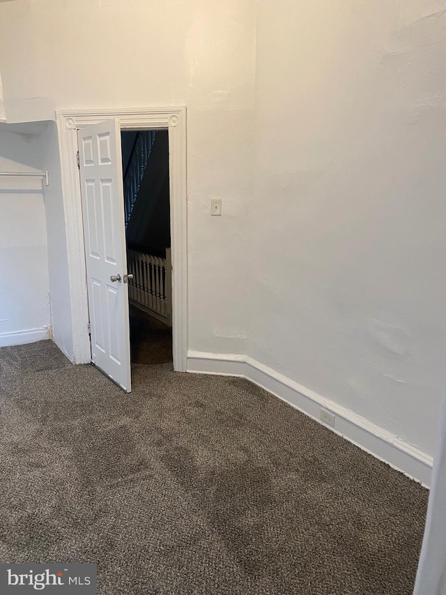 unfurnished bedroom featuring carpet and baseboards