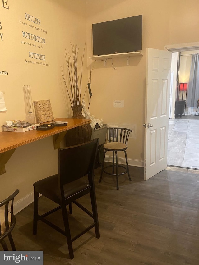 interior space featuring wood finished floors and baseboards