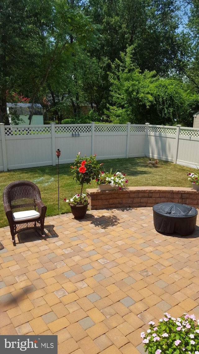 view of patio / terrace featuring fence private yard and an outdoor fire pit