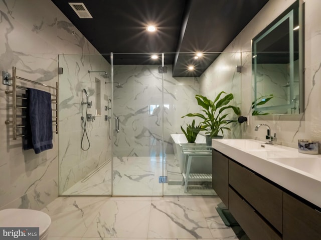 full bathroom featuring stone wall, double vanity, a marble finish shower, and visible vents