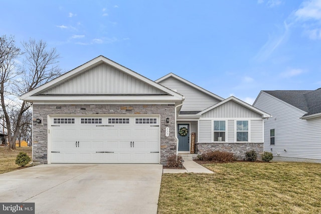 view of front of house featuring a garage, driveway, stone siding, and a front yard