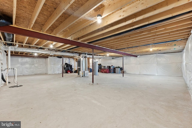 unfinished basement featuring water heater