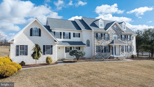 view of front of house with stone siding and a front lawn