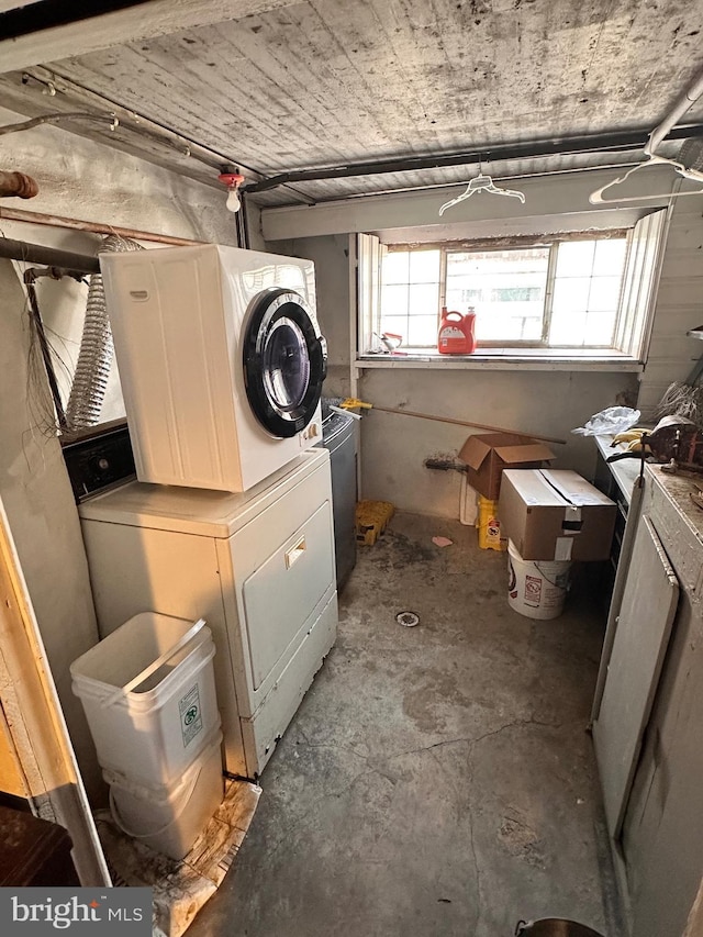 clothes washing area featuring washer / clothes dryer and laundry area